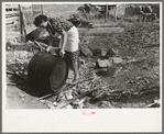 Spanish-American client rinsing soap kettle before using, Taos County, New Mexico