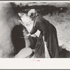 Determining temperature of earthen oven in which bread will be baked by seeing how fast straw will burned, Taos Co., N.M