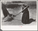 Putting out hot coals with wet cloth, Taos Co., N.M
