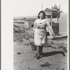 Child of Spanish-American FSA client bringing water from well, Taos County, N.M