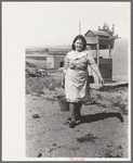 Child of Spanish-American FSA client bringing water from well, Taos County, N.M