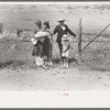 Spanish-American family waiting at the gate at Bean Day Rodeo, Wagon Mound, N.M