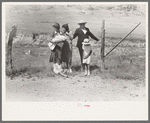 Spanish-American family waiting at the gate at Bean Day Rodeo, Wagon Mound, N.M