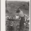 Splitting wood, getting ready for the winter, on farm near Bradford, Vermont