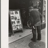 Old man looking at stills of Joe Lewis fight picture, Windsor Locks, Conn