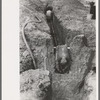 Laying sewer pipe in migrant camp in Sinton, Texas