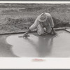 Smoothing concrete floor in construction of migrant camp, Sinton, Texas