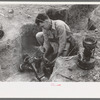 Soldering a joint of cast iron sewer pipe at migrant camp under construction at Sinton, Texas