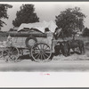 Farmer moving in wagon from farm to a new farm. He had stopped for rest and repair along roadside in Smith County, Texas