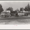 Farmer moving in wagon from old farm to a new one. He had stopped on the roadside for rest and repairs. Smith County, Texas