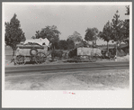 Farmer moving in wagon from old farm to a new one. He had stopped on the roadside for rest and repairs. Smith County, Texas