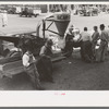 Farmers around agricultural machine, Jacksonville, Texas