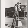 Painting traffic lights, Taylor, Texas