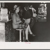 Woman sitting at soda fountain, Taylor, Texas