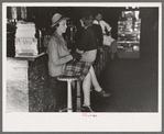 Woman sitting at soda fountain, Taylor, Texas