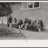 Men sitting on a bench at county fair, Gonzales, Texas