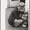Man looking at wrench. Market square, Waco, Texas