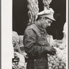 Mexican worker paying for merchandise. Market square, Waco, Texas