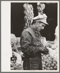 Mexican worker paying for merchandise. Market square, Waco, Texas
