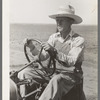 Day laborer at wheel of tractor on large farm near Ralls, Texas