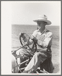 Day laborer at wheel of tractor on large farm near Ralls, Texas