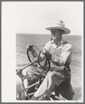 Day laborer at wheel of tractor on large farm near Ralls, Texas