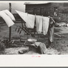 Daughter of tenant farmer hanging up clothes near Warner, Oklahoma