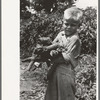 Son of day laborer with load of wood in his arms, near Webber Falls, Muskogee County, Oklahoma