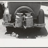 Milk cans tied on back of farm automobile, Muskogee, Oklahoma