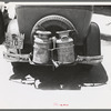 Milk cans tied on back of farm automobile, Muskogee, Oklahoma