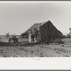 Tractor plowing near abandoned and wrecked tenant house, Wagoner County, Oklahoma