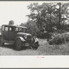 Automobile of family camped by the roadside while they did agricultural day labor in the neighborhood to secure funds to continue westward to Arizona and Califormia. This camp was near Spiro, Oklahoma