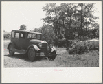 Automobile of family camped by the roadside while they did agricultural day labor in the neighborhood to secure funds to continue westward to Arizona and Califormia. This camp was near Spiro, Oklahoma