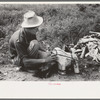 Itinerant statue maker putting together the pieces of a mold for one of his statues. He had been at one time an oil field worker. He said that the WPA (Work Projects Administration) had reduced the possibility of the man on the road getting a job