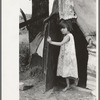 Child of agricultural day laborer coming out of tent near Spiro. Sequoyah County, Oklahoma