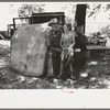 Veteran migrant agricultural worker with his daughter camped on Arkansas River, Wagon County, Oklahoma