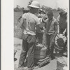 Receiving check for string beans picked at scales in field near Muskogee, Oklahoma