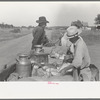 Farm wagon leaving small grocery store on Saturday afternoon, McIntosh County, Oklahoma