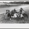 White migrant family eating lunch of blackberry pie on the highway east of Fort Gibson, Oklahoma