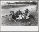 White migrant family eating lunch of blackberry pie on the highway east of Fort Gibson, Oklahoma