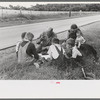White migrant family eating lunch of blackberry pie on the highway east of Fort Gibson, Oklahoma