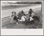 White migrant family eating lunch of blackberry pie on the highway east of Fort Gibson, Oklahoma