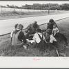 White migrant family eating lunch of blackberry pie on the highway east of Fort Gibson, Oklahoma