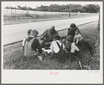 White migrant family eating lunch of blackberry pie on the highway east of Fort Gibson, Oklahoma