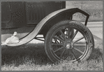 Detail of automobile of white migrant family with sack of salt on running board and leather-laced tire, Fort Gibson, Oklahoma