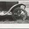 Detail of automobile of white migrant family with sack of salt on running board and leather-laced tire, Fort Gibson, Oklahoma