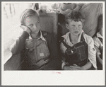 White migrant children sitting in back seat of family car east of Fort Gibson, Muskogee County, Oklahoma