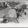 Burning out the horns of a calf. Roundup near Marfa, Texas