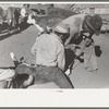 Burning out the horns of a calf. Roundup near Marfa, Texas