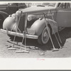 Polo mallets in front of automobile, Abilene, Texas